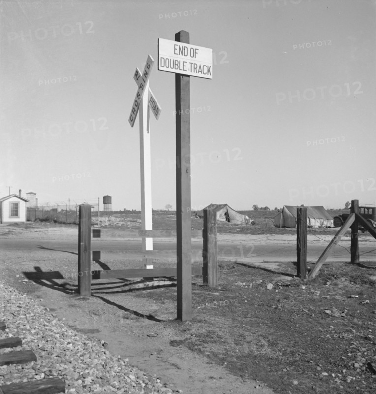 Migrants' tents...along the right of way of the southern pacific, near Fresno, California, 1939. Creator: Dorothea Lange.
