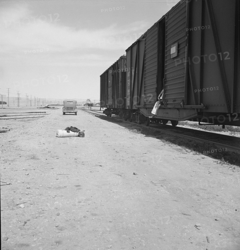 Car on siding across tracks from pea packing plant, Calipatria, Imperial Valley, 1939. Creator: Dorothea Lange.