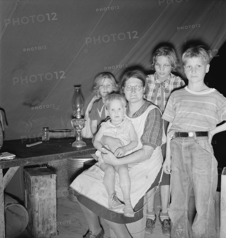 Family of six in tent after supper, FSA mobile unit, Merrill, Klamath County, Oregon, 1939 Creator: Dorothea Lange.