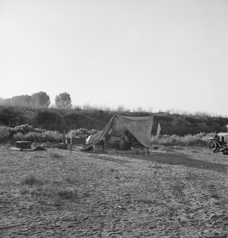 Young family on ditch bank, waiting to enter... camp (FSA), Merrill, Klamath County, Oregon, 1939. Creator: Dorothea Lange.