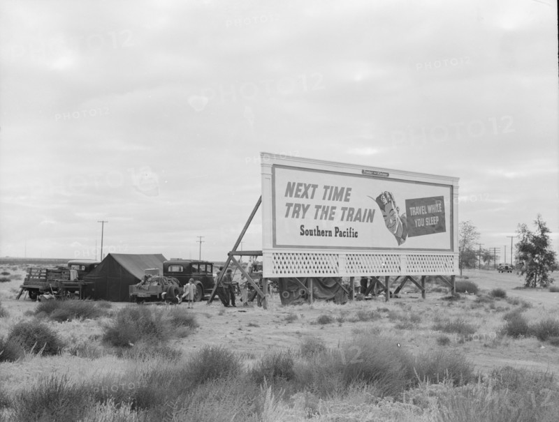 Camped in the rain behind billboard...on U.S. 99, near Famosa, Kern County, California, 1939. Creator: Dorothea Lange.