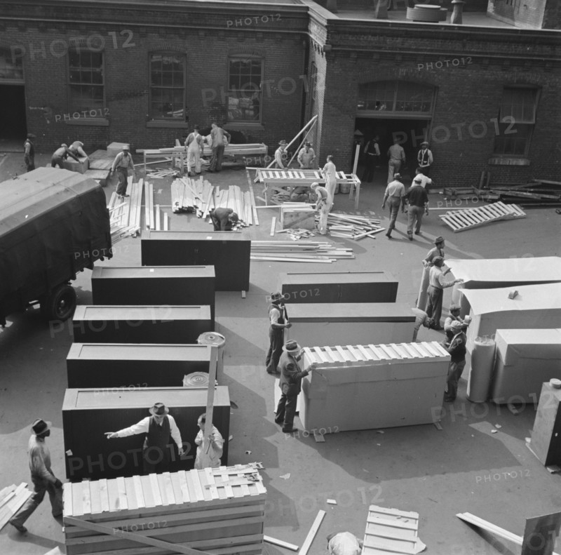 United States government workers and carpenters making crates for steel... Washington, D.C., 1942. Creator: Gordon Parks.