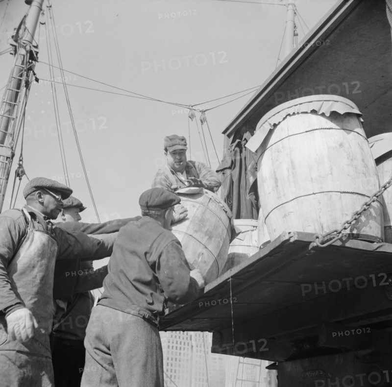 Dock worker at the Fulton fish market loading fish that have been caught..., New York, 1943. Creator: Gordon Parks.