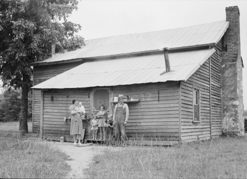 Tobacco sharecropper and his family at the back..., Person County, North Carolina, 1939. Creator: Dorothea Lange.