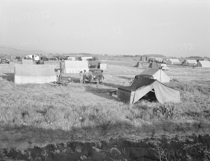 Families camped on flat before season opens waiting..., near Merrill, Klamath County, Oregon, 1939. Creator: Dorothea Lange.