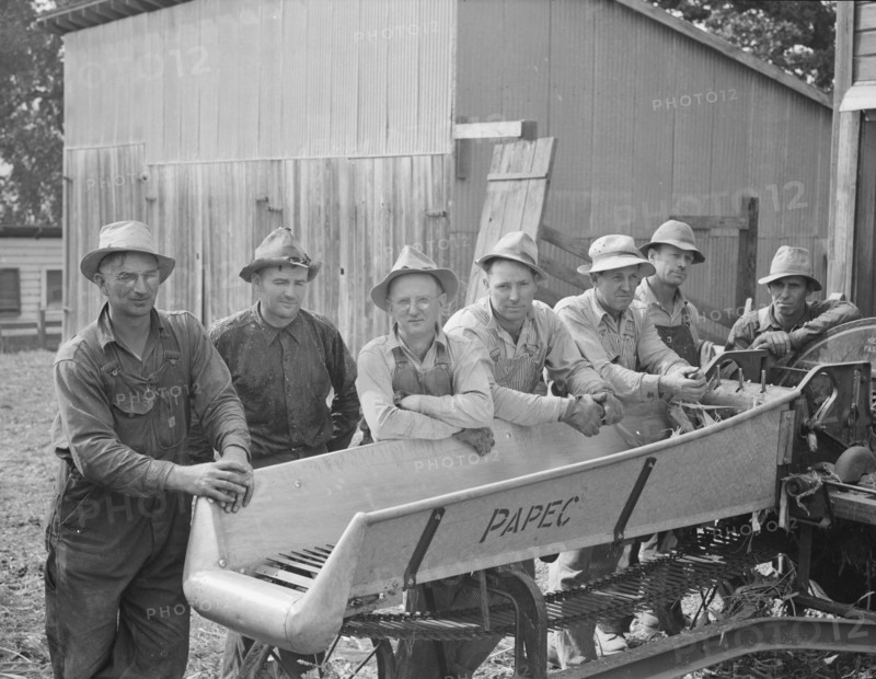 Seven of the eight farmers shown with their coop...West Carlton, Yamhill County, Oregon, 1939. Creator: Dorothea Lange.