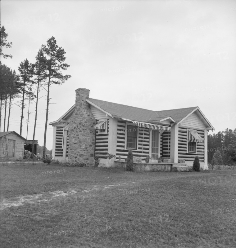 A new very fancy log bungalow..., near Gordonton, North Carolina, 1939. Creator: Dorothea Lange.