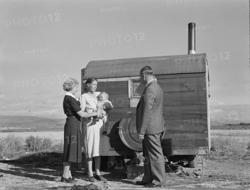The doctor reassures the mother...the sick baby, Merrill, Klamath County, Oregon, 1939. Creator: Dorothea Lange.