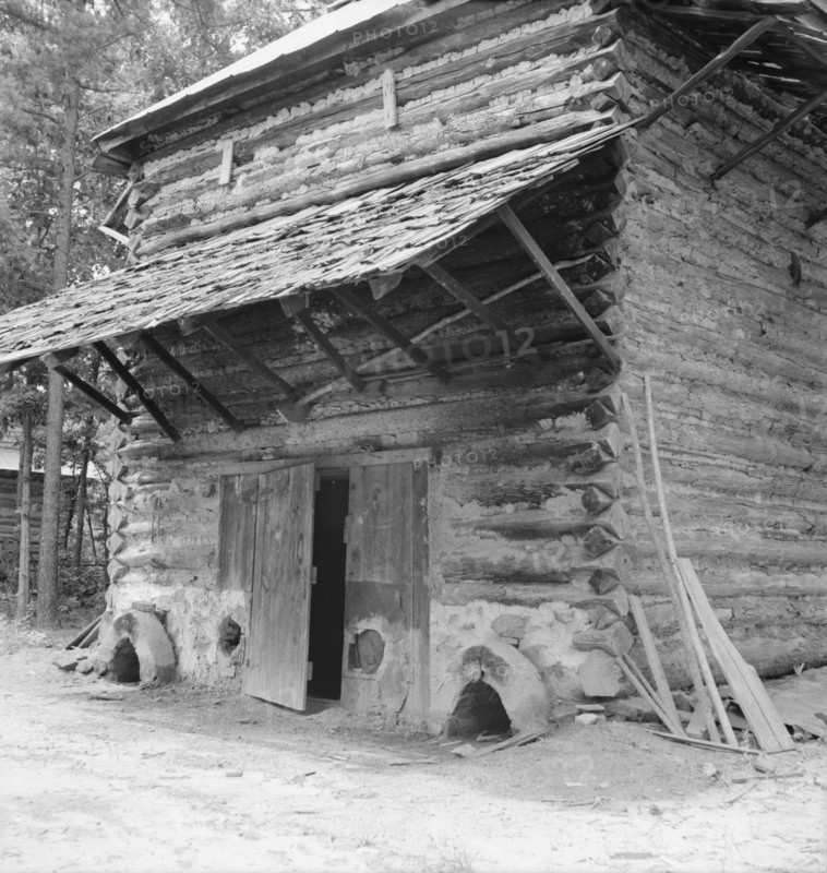 Tobacco barn with newly plastered furnace..., Person County, North Carolina, 1939. Creator: Dorothea Lange.