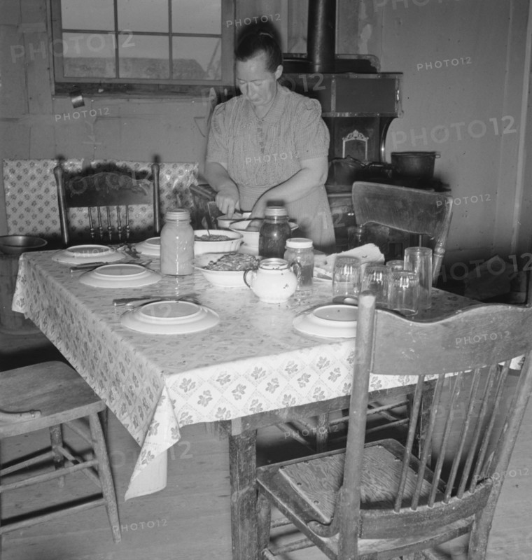Mrs. Wardlow bakes her own bread in her dugout house, Dead Ox Flat, Oregon, 1939. Creator: Dorothea Lange.