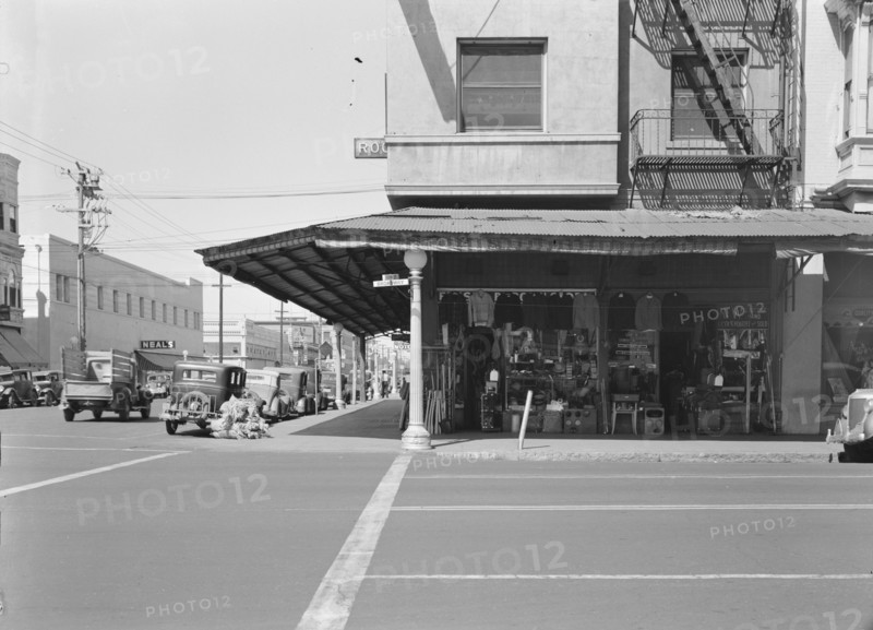 Street corner of San Joaquin Valley town on U.S. 99 showing secondhand store, Fresno, CA, 1939. Creator: Dorothea Lange.