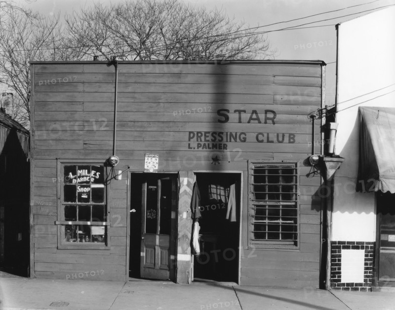 Negro shop, Shop fronts, laundry and barber shop, Vicksburg, Mississippi, 1936. Creator: Walker Evans.