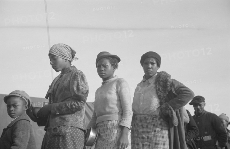 Possibly: Negroes in the lineup for food at meal time in the camp..., Forrest City, Arkansas, 1937. Creator: Walker Evans.