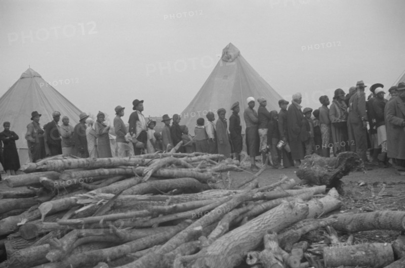 Possibly: Negroes in the lineup for food at meal time in the camp..., Forrest City, Arkansas, 1937. Creator: Walker Evans.