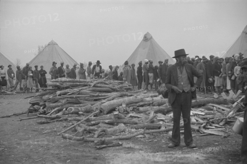 Possibly: Negroes in the lineup for food at meal time in the camp..., Forrest City, Arkansas, 1937. Creator: Walker Evans.