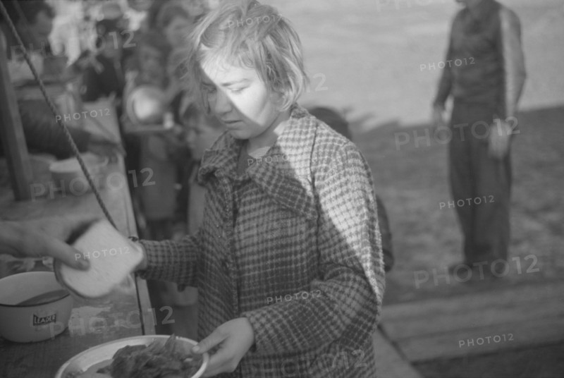 Possibly: Negroes in the lineup for food at mealtime in the camp..., Forrest City, Arkansas, 1937. Creator: Walker Evans.