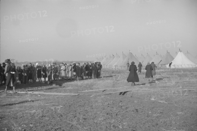 Possibly: Negroes in the lineup for food at mealtime in the camp..., Forrest City, Arkansas, 1937. Creator: Walker Evans.