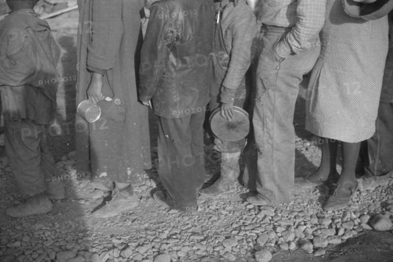 Possibly: Negroes in the lineup for food at mealtime in the camp..., Forrest City, Arkansas, 1937. Creator: Walker Evans.