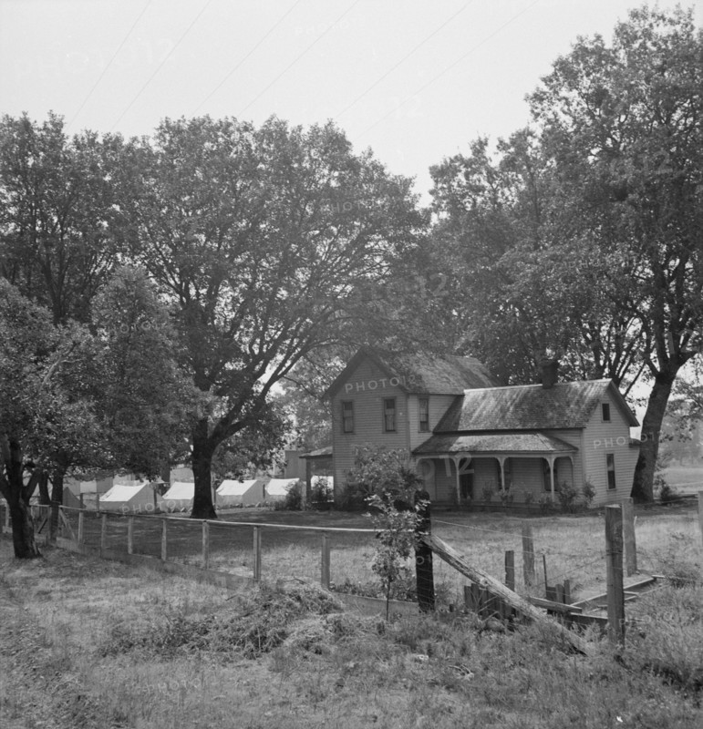 Hop grower's home on Rogue River, with the tent camp he..., near Medford, Jackson County, 1939. Creator: Dorothea Lange.