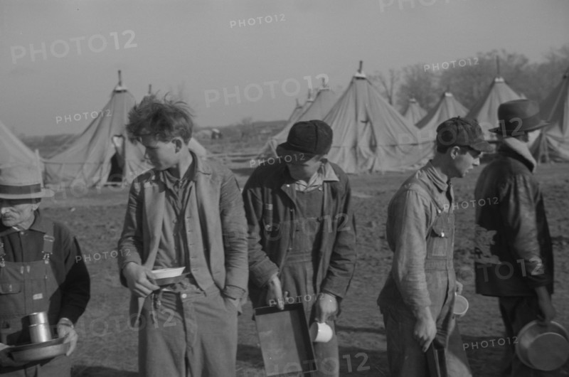 Possibly: Refugees lined up at meal time in the camp for white flood...Forest City, Arkansas, 1937. Creator: Walker Evans.