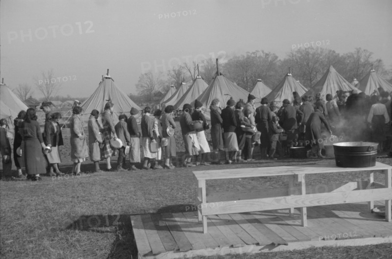 Possibly: Refugees lined up at meal time in the camp for white flood...Forest City, Arkansas, 1937. Creator: Walker Evans.