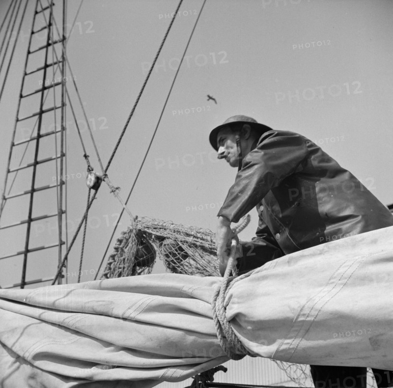 Possibly:  A New England fisherman preparing his boat to leave the New York docks, 1943. Creator: Gordon Parks.