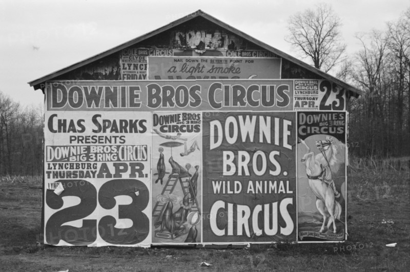 Posters covering a building near Lynchburg to advertise a Downie Bros. circus, 1936. Creator: Walker Evans.