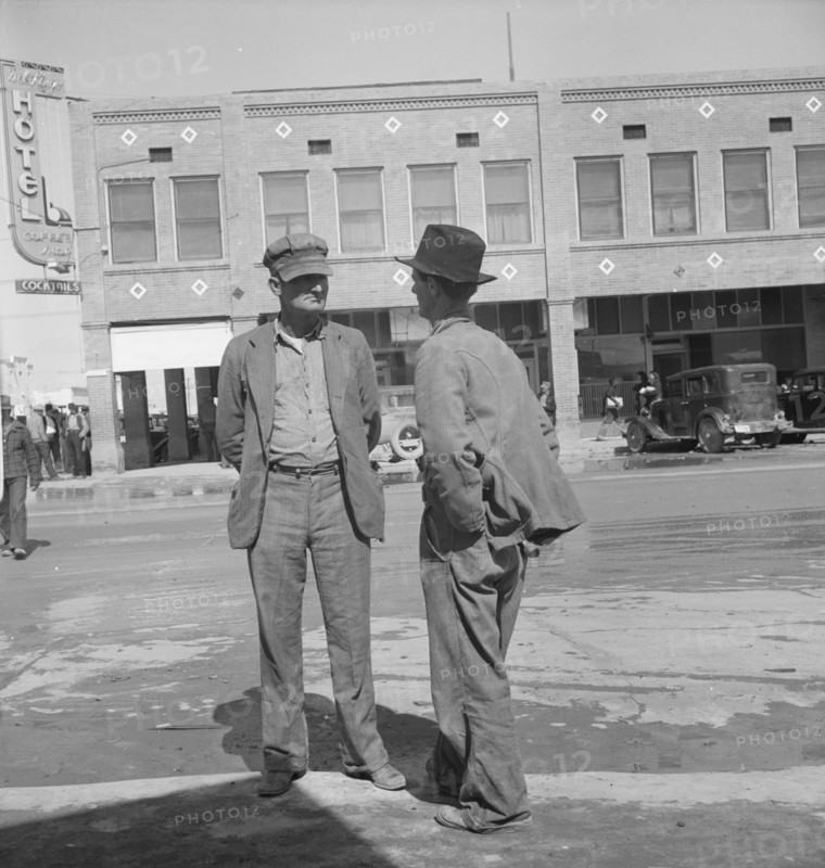 Idle pea pickers discuss prospects for work, Calipatria, Imperial Valley, CA, 1939. Creator: Dorothea Lange.