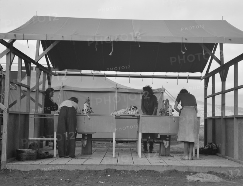 Portable laundry unit, shower unit beyond, FSA camp, Merrill, Oregon, 1939. Creator: Dorothea Lange.