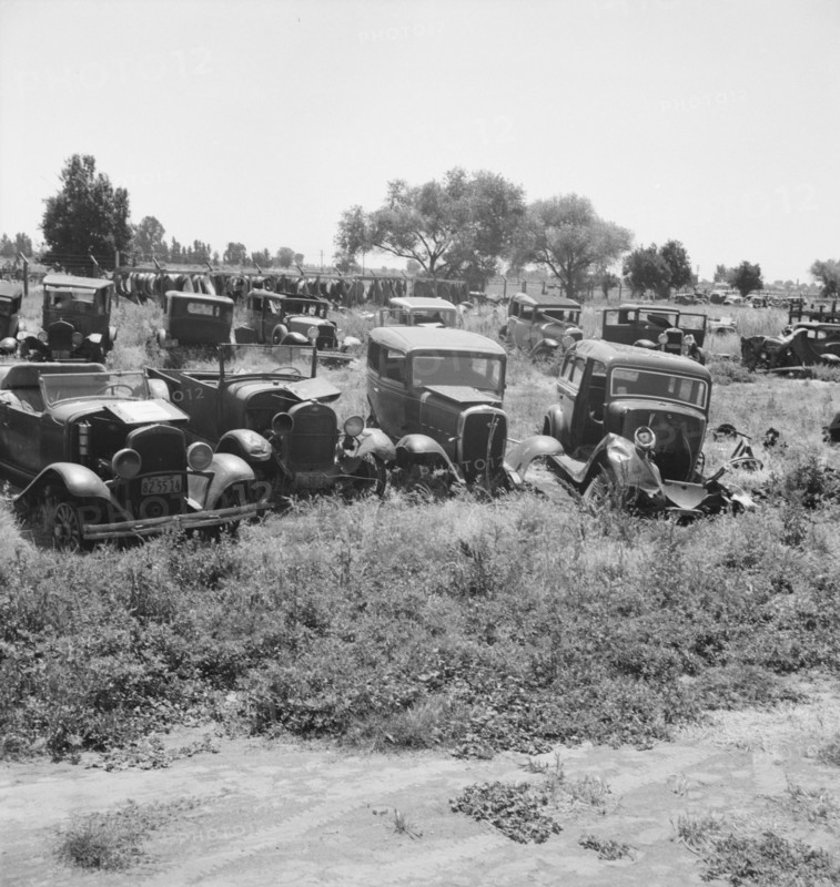 Used car lots and auto wrecking establishments, U.S. 99,  Near Tulare, California, 1939. Creator: Dorothea Lange.