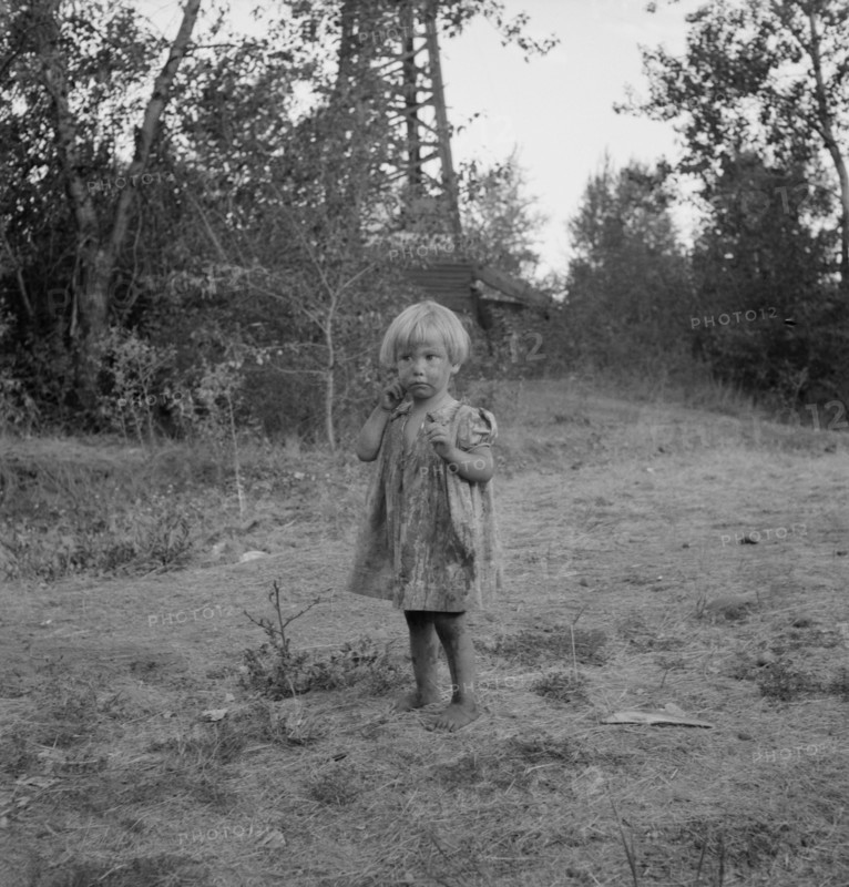 Migratory child in squatter camp before hop season opens, Washington, Yakima Valley, 1939. Creator: Dorothea Lange.