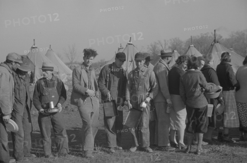 Possibly: Negroes in the lineup for food at the flood refugee camp, Forrest City, Arkansas, 1937. Creator: Walker Evans.