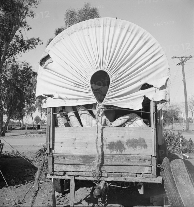 Covered wagon, migratory carrot puller's camp, near Holtville, Imperial Valley, 1939. Creator: Dorothea Lange.