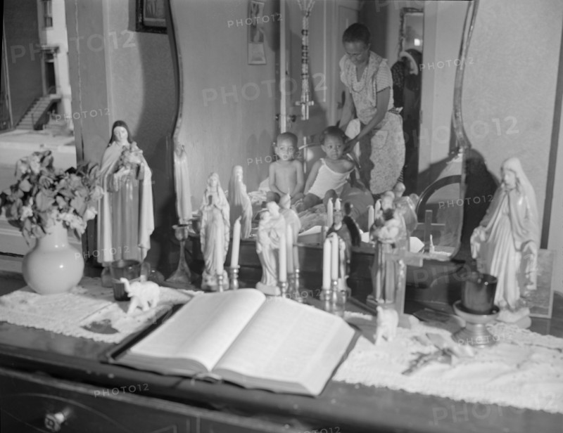 Religious objects and an improved altar in the bedroom..., Washington, D.C., 1942. Creator: Gordon Parks.