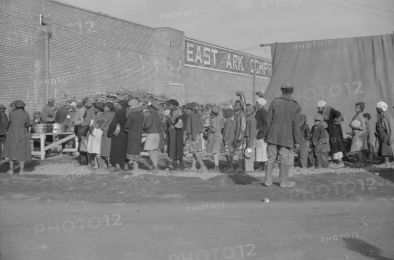 Possibly: Negroes at mealtime in the flood refugee camp, Forrest City, Arkansas, 1937. Creator: Walker Evans.