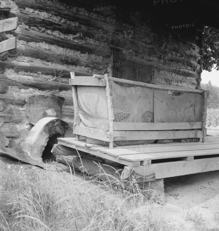Tobacco barn with tobacco sled and vehicle used..., Person County, North Carolina, 1939. Creator: Dorothea Lange.