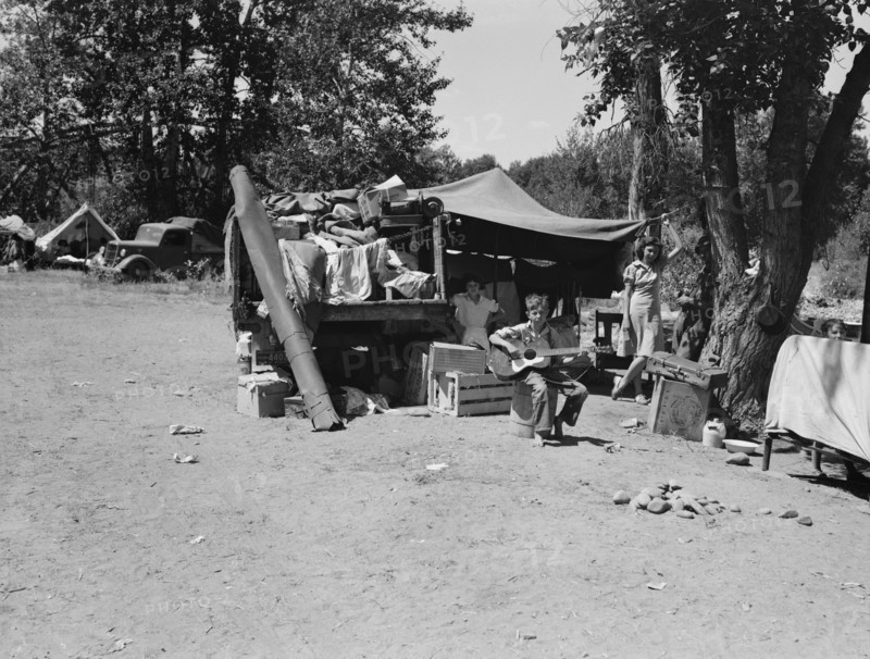 Camp of family with nine children...on the road for three years, Washington, Yakima Valley, 1939. Creator: Dorothea Lange.