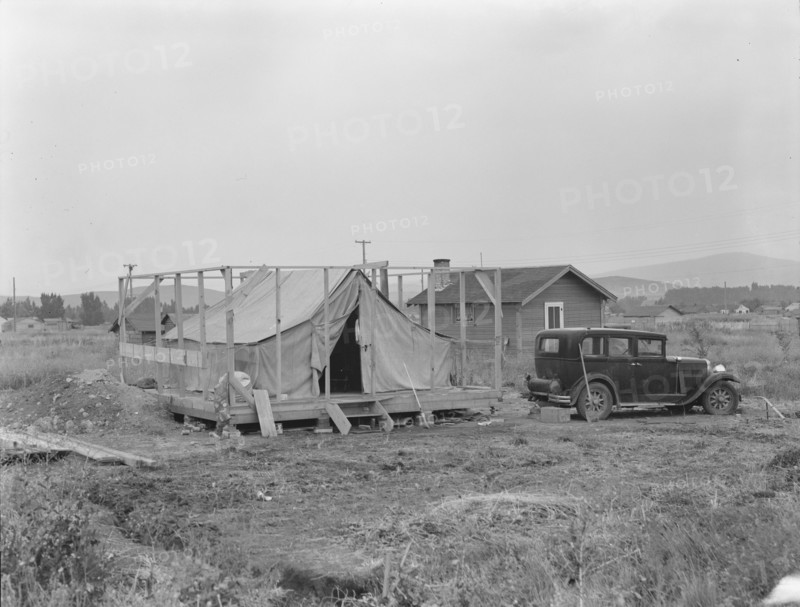 Family living in tent while building the house around them, near Klamath Falls, Oregon, 1939. Creator: Dorothea Lange.