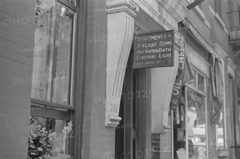 New York, New York. 61st Street between 1st and 3rd Avenues. A sign offering apartments for rent.