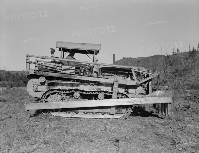 Western Washington, Lewis County. Caterpillar clearing land on cut-over western Washington farm.