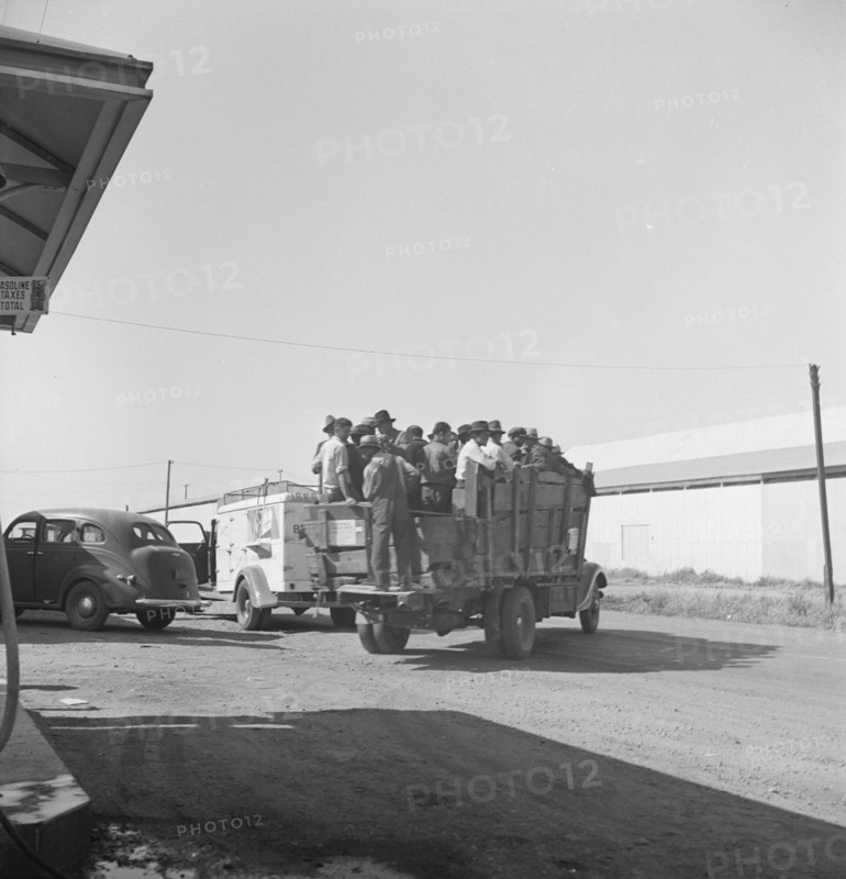 Labor contractor's truck with gang of pea pickers, pulled up for gas. Near Westley, California.