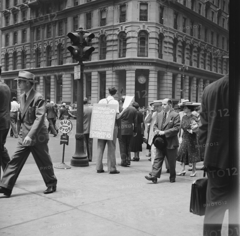 42nd Street and Madison Avenue. Street hawker selling Consumer's Bureau Guide. New York City.