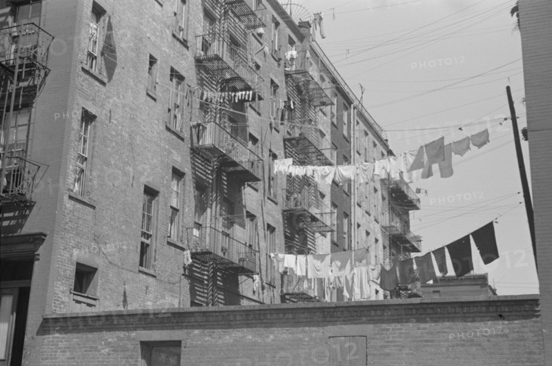 New York, New York. 61st Street between 1st and 3rd Avenues. Apartment houses from the rear.