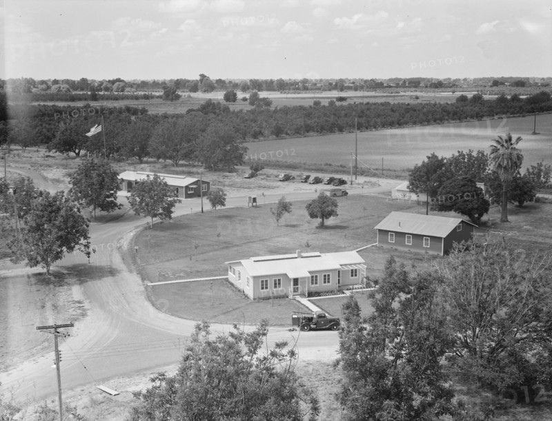 Entrance to camp showing clinic (light building in foreground). Farmersville, California.
