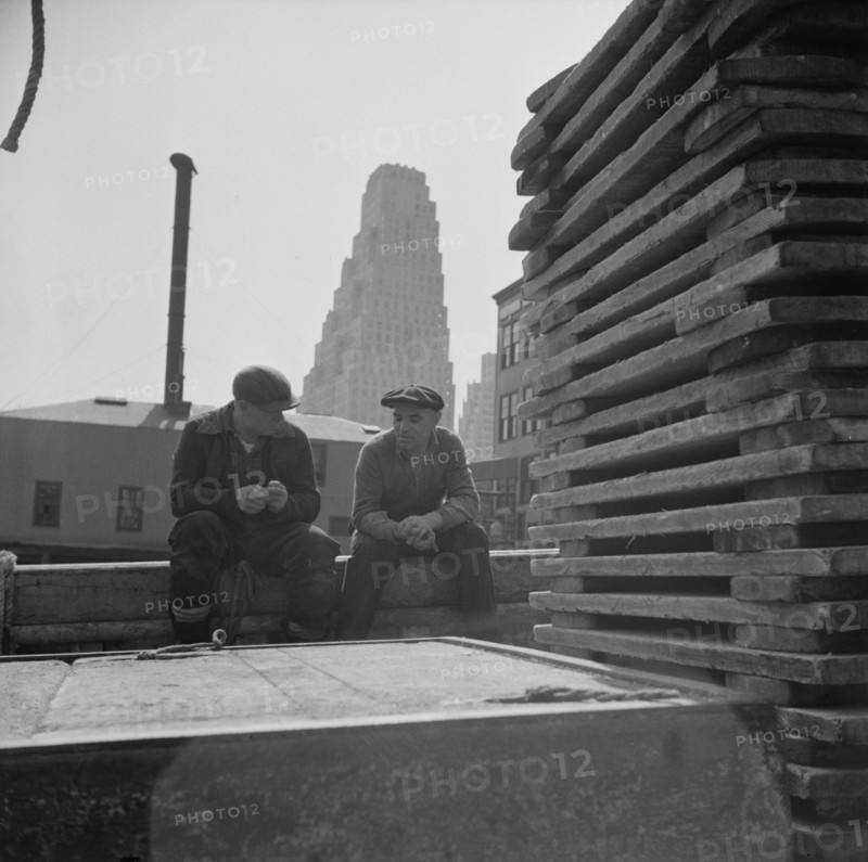 New York, New York. Gloucester fishermen resting on their boat at the Fulton fish market.