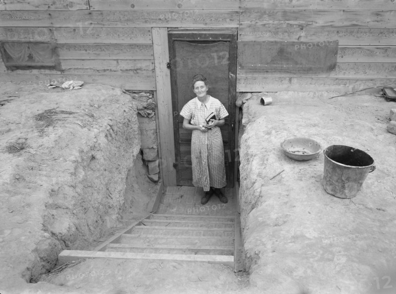 Mrs. Free in doorway of her basement dugout home. Dead Ox Flat, Malheur County, Oregon.