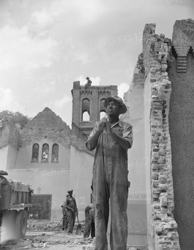 Washington, D.C. Construction workman wrecking a church on Independence Avenue.