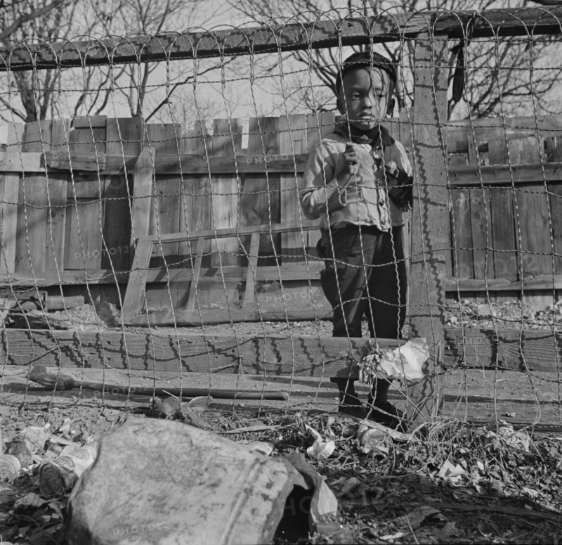 Washington (southwest section), D.C. Boy playing in the backyard of his home.