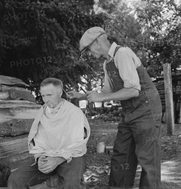 Oregon, Marion County, near West Stayton. Bean pickers barber each other.