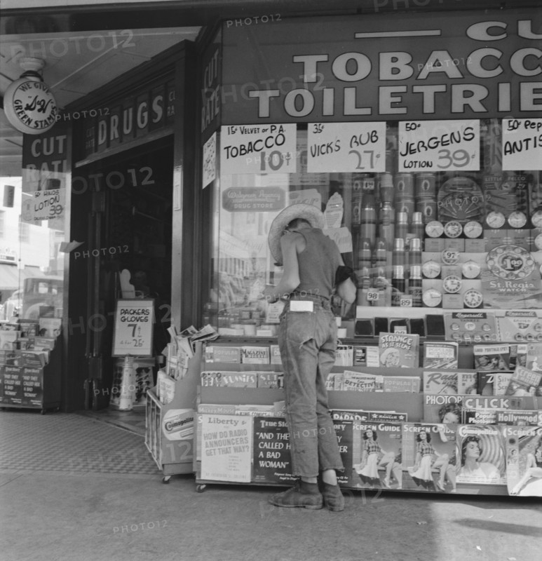 Oregon. Medford. Half-grown farm boy on main drugstore corner in town.